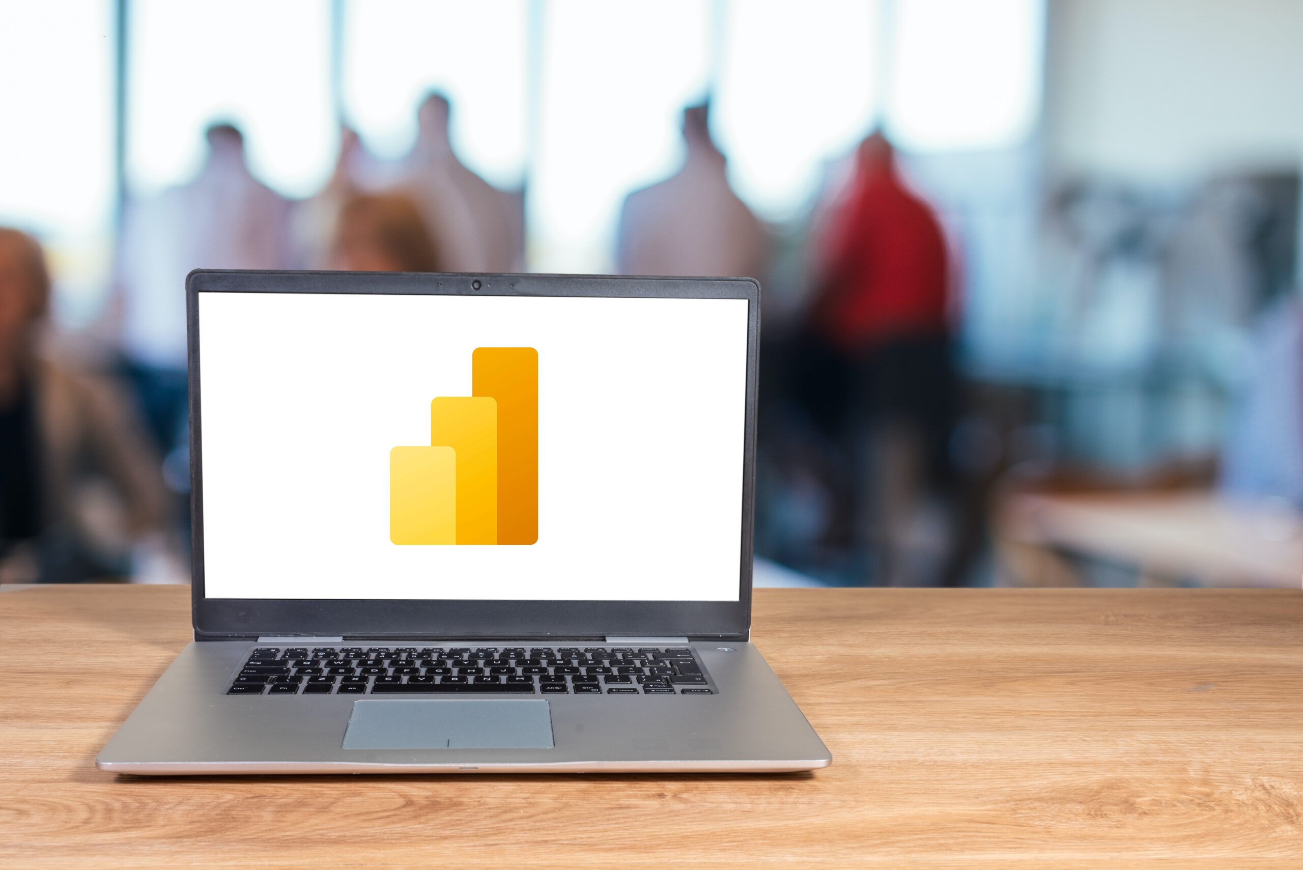 Microsoft Power BI logo displayed on a laptop screen.